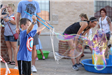 Kid Making a Huge Bubble with a Special Tool