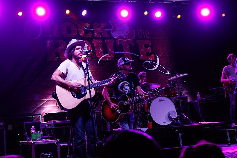 Man in a White Shirt and Fedora Playing Acoustic Guitar