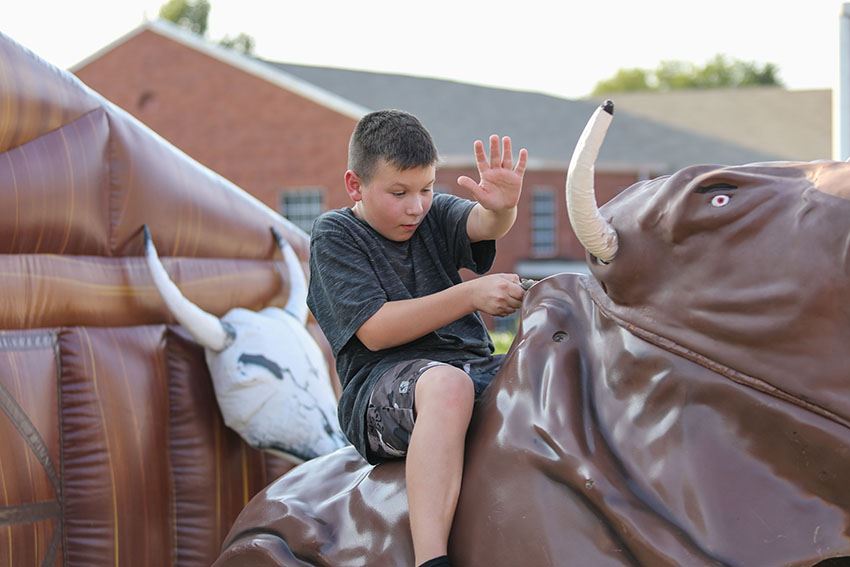 Kid Riding a Bucking Bull Machine