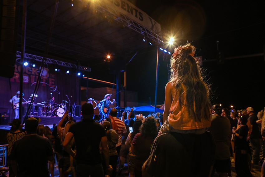 Kid on Her Dads Shoulders to Get a Better View of the Show